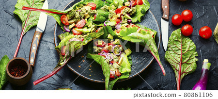Spring vegetable salad in chard leaves 80861106