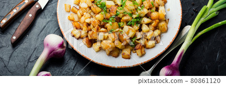 Fried potatoes with green onions 80861120