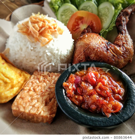 Fried chicken leg, tempeh, tofu, and salad. Traditional dish West Java, Indonesia. Fried chicken leg, tempeh, tofu, and salad. Traditional dish West Java, Indonesia. 80863644