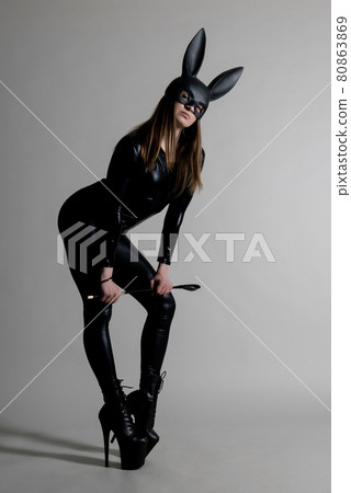 Sexy beautiful woman pole dancer posing in latex costum Sexy beautiful woman pole dancer posing in latex costum 80863869