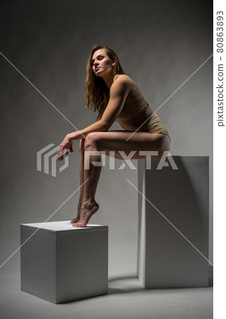 Beautiful sporty girl posing on cubes 80863893