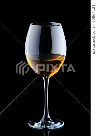 Glass with white wine isolated on black 80864121