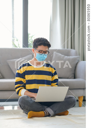 Asian student with a lot of books and laptop preparing for exam at home Asian student with a lot of books and laptop preparing for exam at home 80865950