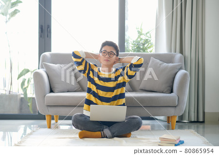 Asian student with a lot of books and laptop preparing for exam at home Asian student with a lot of books and laptop preparing for exam at home 80865954