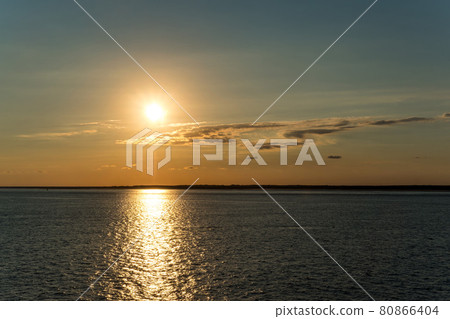Sunset reflected on the calm sea surface Sunset reflected on the calm sea surface 80866404