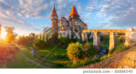 hunedoara, romania - OCT 13, 2019: corvin castle at sunrise. panoramic view of medieval fortification in morning light. one of the most beautiful landmarks in transylvania. popular travel destination 80866540