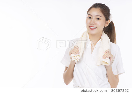 Cheerful young woman wear bathrobe holding towel on her neck in bathroom after finished shower Cheerful young woman wear bathrobe holding towel on her neck in bathroom after finished shower 80867262