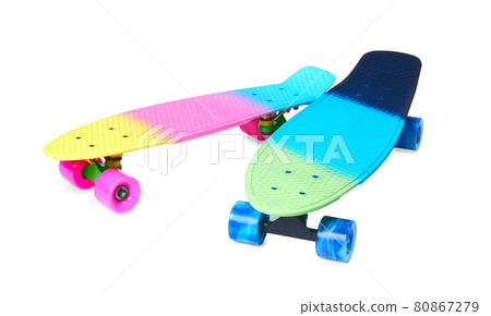 Two rainbow plastic Penny board skateboards on white background Two rainbow plastic Penny board skateboards on white background 80867279