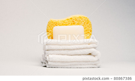Soap, towels and body sponge over light background 80867386