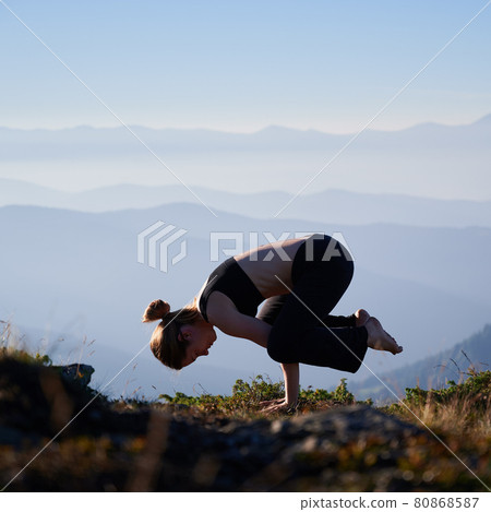 Female is balancing on two arms. 80868587