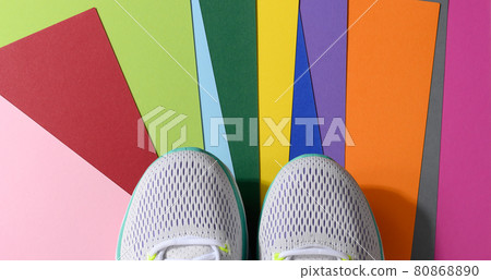 white women's sneakers with laces on a color background, top view 80868890