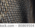 selective focus of dark metal mesh fence 80869504