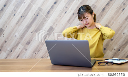Tired business woman worried about stiff shoulders and neck pain while working in the office Tired business woman worried about stiff shoulders and neck pain while working in the office 80869550