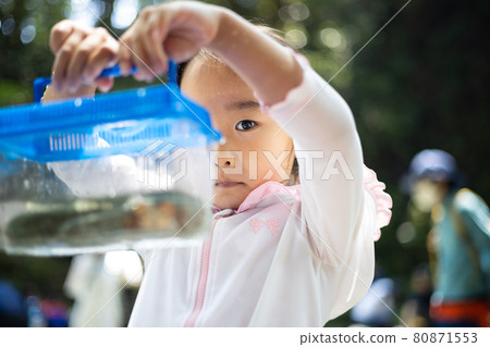 Girl enjoying playing in the river Girl enjoying playing in the river 80871553