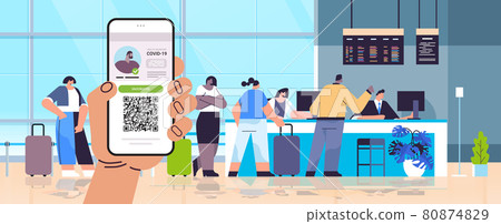 hand holding smartphone with digital immunity passport with qr code on screen risk free covid-19 pandemic hand holding smartphone with digital immunity passport with qr code on screen risk free covid-19 pandemic 80874829
