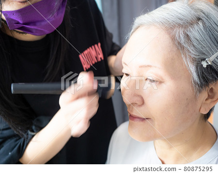 Senior asian woman and make up artist. Senior asian woman and make up artist. 80875295
