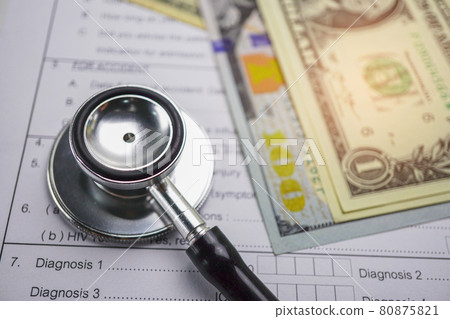 Health insurance accident claim form with stethoscope and US dollar banknotes, Medical concept. . Health insurance accident claim form with stethoscope and US dollar banknotes, Medical concept. . 80875821