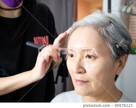 Senior asian woman and make up artist. Senior asian woman and make up artist. 80876123