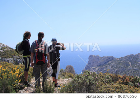 Male and female hikers looking out at the sea Male and female hikers looking out at the sea 80876550