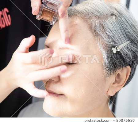 Senior asian woman and make up artist. Senior asian woman and make up artist. 80876656