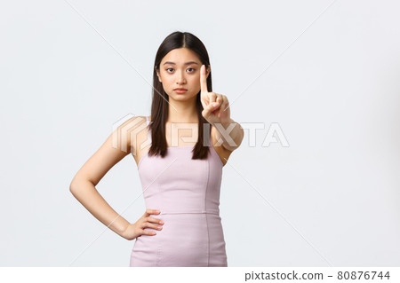 Luxury women, party and holidays concept. Not so fast. Serious-looking asian woman in evening dress shaking finger in denial, rejection or prohibition, tell to stop, disapprove or disagree Luxury women, party and holidays concept. Not so fast. Serious-looking asian woman in evening dress shaking finger in denial, rejection or prohibition, tell to stop, disapprove or disagree 80876744