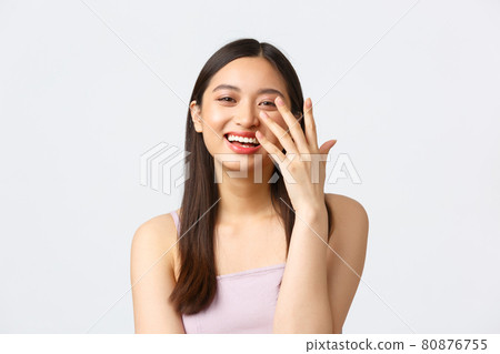 Beauty, fashion and people emotions concept. Close-up portrait of pretty smiling asian woman laughing coquettish, having fun at celebration event, enjoying party, standing white background Beauty, fashion and people emotions concept. Close-up portrait of pretty smiling asian woman laughing coquettish, having fun at celebration event, enjoying party, standing white background 80876755