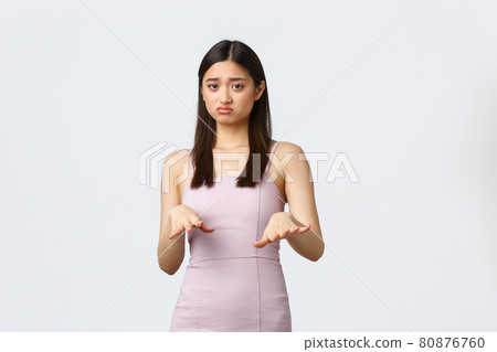 Luxury women, party and holidays concept. Ignorant and picky young rich asian girl in elegant dress, asking stay away, dont come close, rejecting something with dislike and bothered face Luxury women, party and holidays concept. Ignorant and picky young rich asian girl in elegant dress, asking stay away, dont come close, rejecting something with dislike and bothered face 80876760