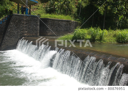 river water flows in the tropical forest in Indonesia. this river is cool and beautiful. 80876951