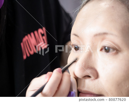 Senior asian woman and make up artist. 80877620