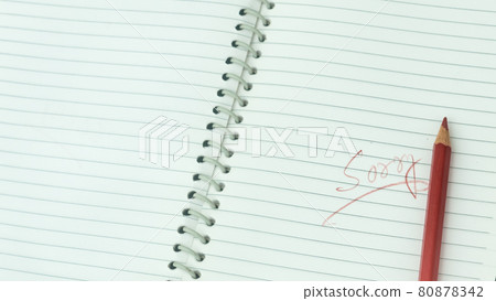 Sorry written on open notebook. Closeup. Mistake learning, blooper, regret sayings in love relationship friendship background. Feelings, apology, reconciliation, misunderstanding concept. 80878342