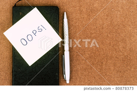 OOPS! Written on sticky notes. Mistake Learning, wrong, blooper, error regret sayings background. Fault, defect, careless lesson correction and reconciliation thought concept. Table top view. Flat Lay 80878373