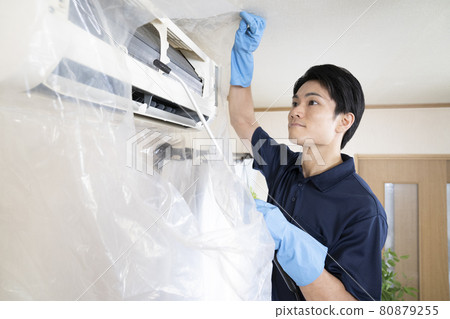 House cleaning worker cleaning the air conditioner House cleaning worker cleaning the air conditioner 80879255