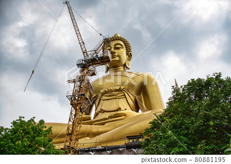 Giant golden buddha statue of Dhammakaya Thep Mongkol Buddha in construction site located at Wat Paknam Bhasicharoen temple 80881195