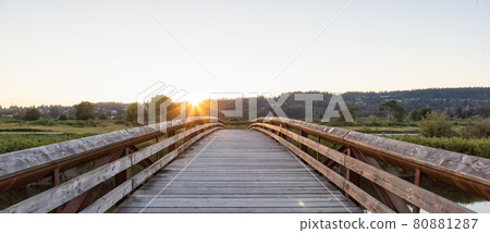 Bridge going over a river in a city park. 80881287