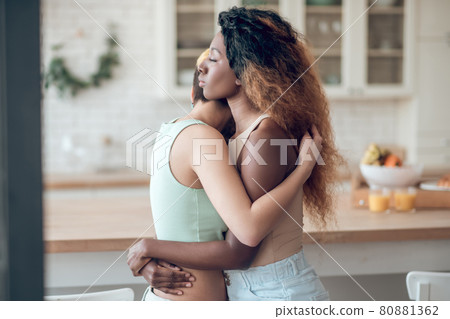 Profile African american woman hugging with girlfriend Profile African american woman hugging with girlfriend 80881362