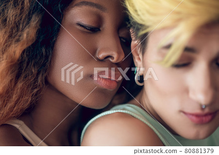 Close-up face of african amarican woman near girlfriend neck 80881379