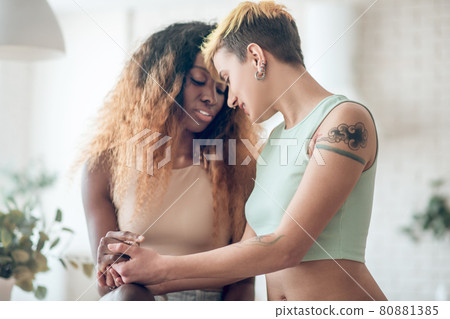 Girlfriends passionate about each other sitting together Girlfriends passionate about each other sitting together 80881385
