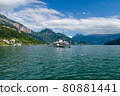 Sunny view of the old wheeled boat sailing near the village of Weggis facing the lake of Luzern with the Swiss mountains in the background 80881441