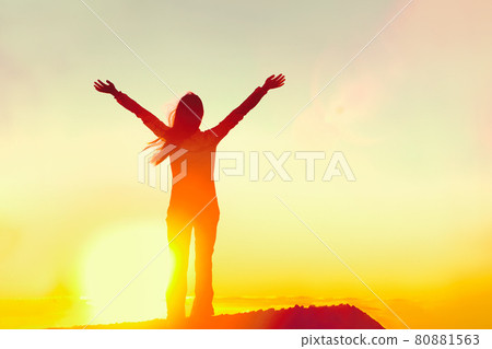 Happy woman sihouette with arms raised up in success celebrating reaching life goal on sunset glow sunshine sunrise. Wellness, financial freedom, healthy life concept background Happy woman sihouette with arms raised up in success celebrating reaching life goal on sunset glow sunshine sunrise. Wellness, financial freedom, healthy life concept background 80881563