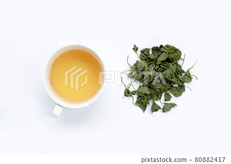 Cup of tea with gotu kola dried leaves on white background. Cup of tea with gotu kola dried leaves on white background. 80882417