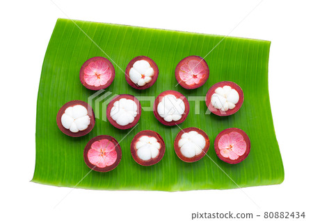 Mangosteen on banana leaf on white Mangosteen on banana leaf on white 80882434
