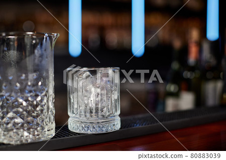 glasses with ice cubes on the wooden table 80883039