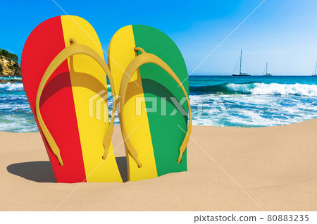 Flip flops with Guinean flag on the beach. Guinea resorts, vacation, tours, travel packages concept. 3D rendering Flip flops with Guinean flag on the beach. Guinea resorts, vacation, tours, travel packages concept. 3D rendering 80883235