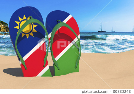 Flip flops with Namibian flag on the beach. Namibia resorts, vacation, tours, travel packages concept. 3D rendering Flip flops with Namibian flag on the beach. Namibia resorts, vacation, tours, travel packages concept. 3D rendering 80883248