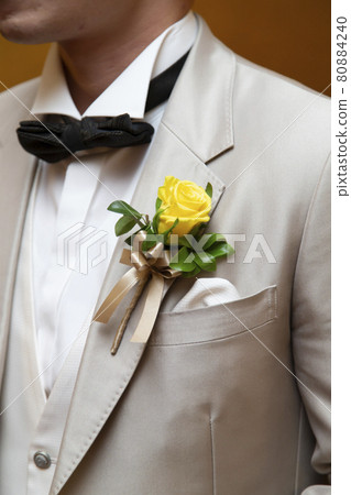 Yellow boutonnière on the groom's chest Yellow boutonnière on the groom's chest 80884240