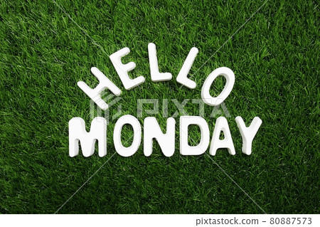 Hello Monday alphabet letter on green grass background 80887573