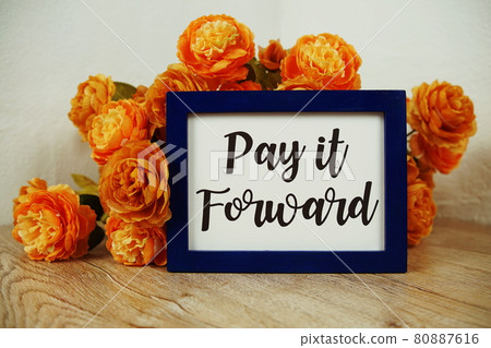 Pay it Forward text and flower bouquet on wooden table interior decoration 80887616