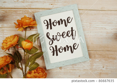 Home Sweet Home typography text with flower decoation on wooden background Home Sweet Home typography text with flower decoation on wooden background 80887635