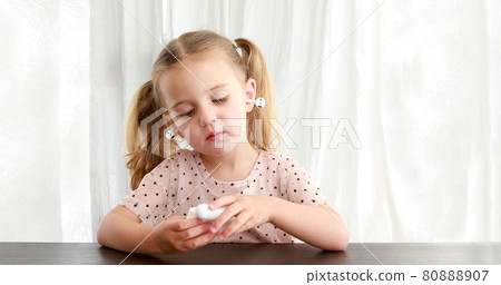 Kid playing with TWS earbuds white background 80888907