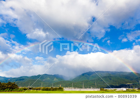 A rainbow over the mountains of the Southern Alps 80891039